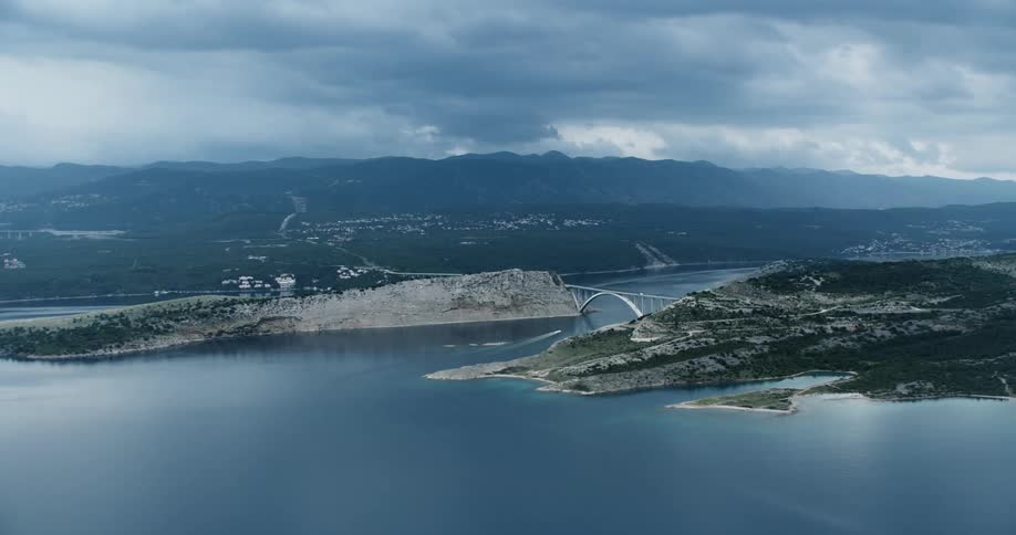 Heavy clouds cover the land by the shore