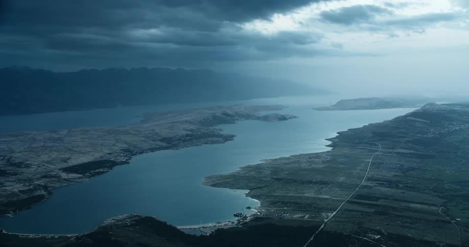 Panorama of an extensive lake with mountains around it on a cloudy day