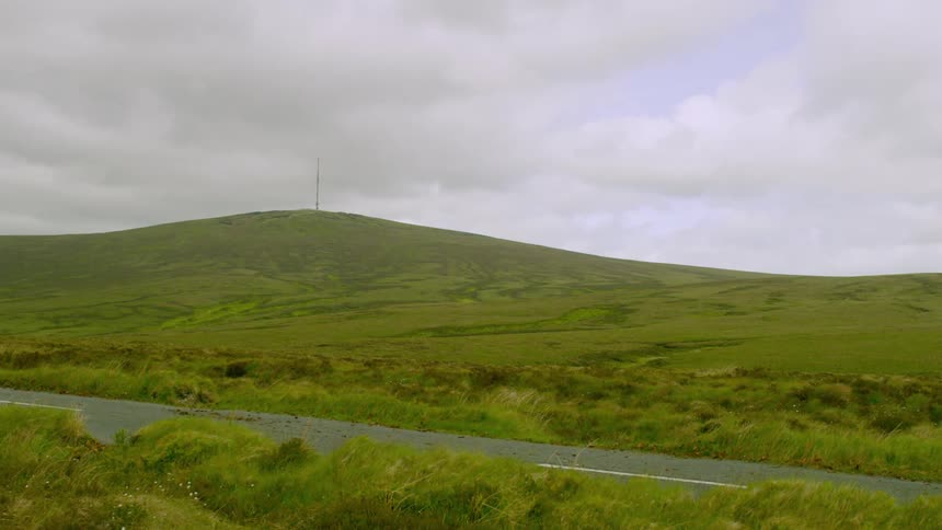 A distant antenna on top of a hill