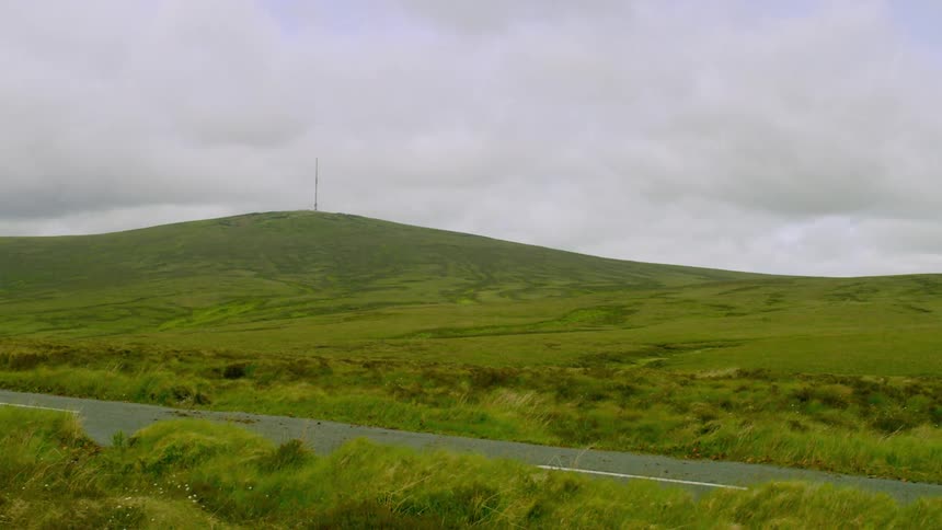 Timelapse of clouds passing over a grassy terrain