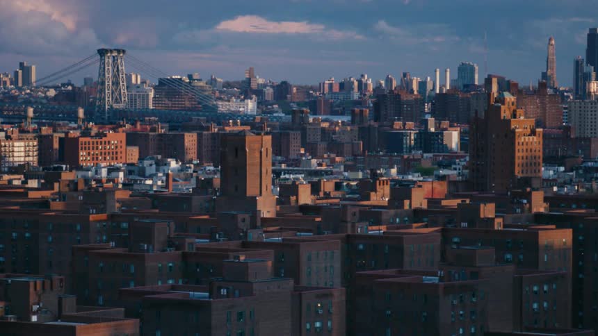A shot of a city skyline beneath a partly cloudy sky