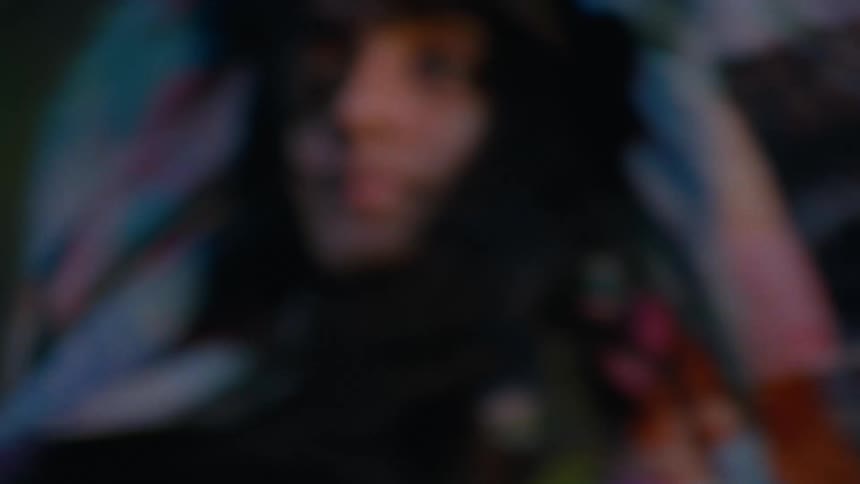 Close up of a young woman wearing earbuds dancing in a room