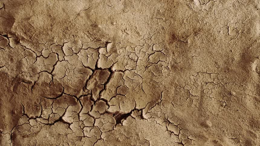 The liquid in the sand dries up and the sand cracks