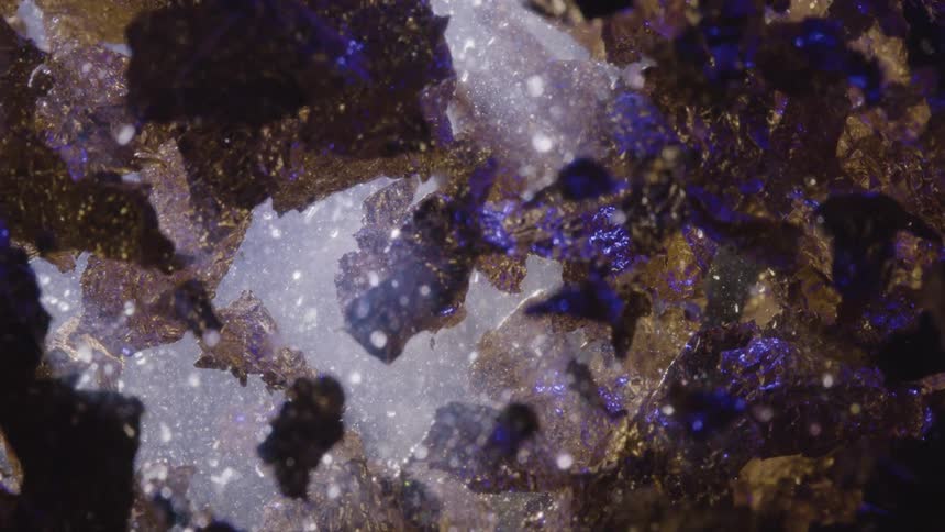 Slowly rotating stones shimmer while reflecting bright blue light