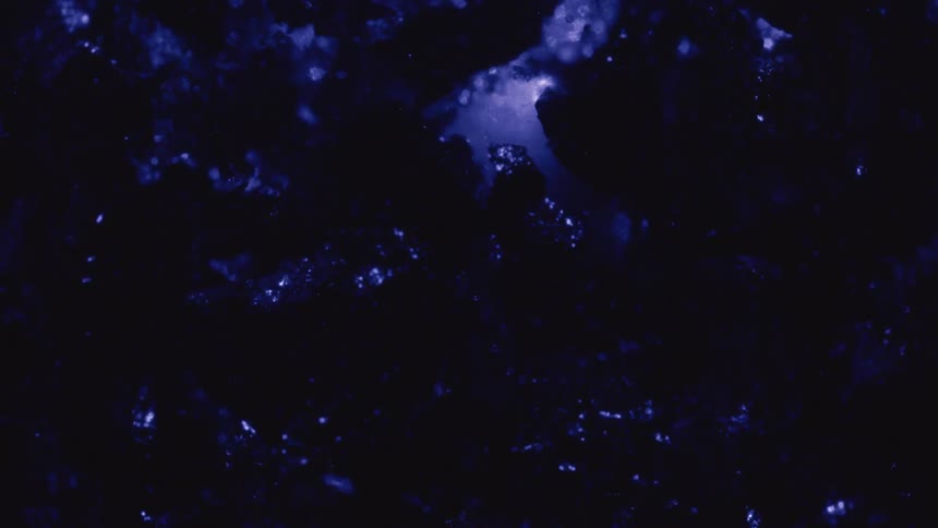 A blue abstract texture with various reflections and is moving