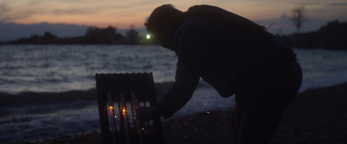 A man lights off firecrackers at the beach
