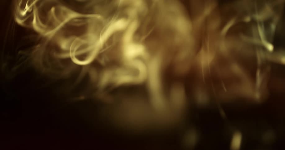 Extreme closeup of sunlight on abstract smoke rising