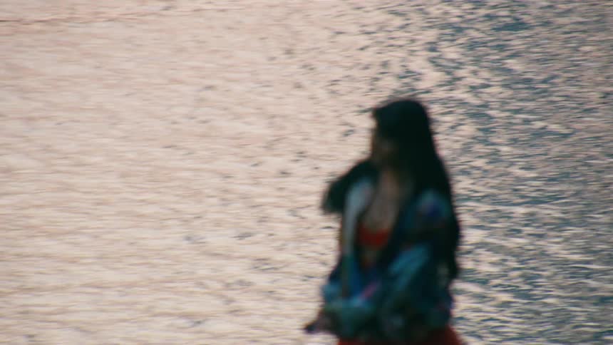 Woman rollerblading on the edge of a lake