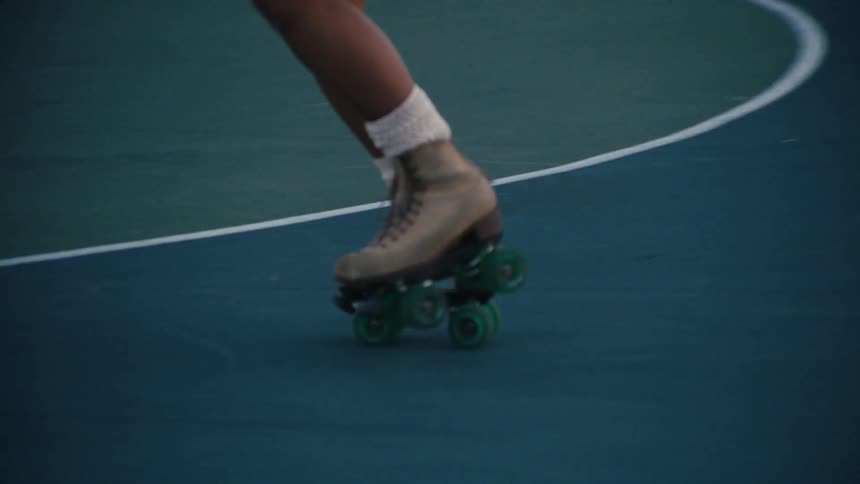 Woman rollerblading on a court