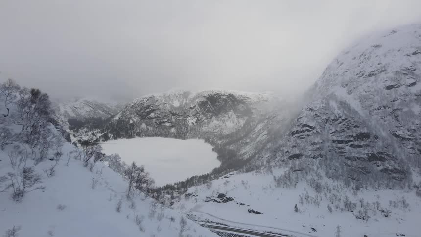 An aerial view of a mountain pass in winter