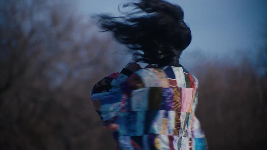 A woman is spinning on roller skates