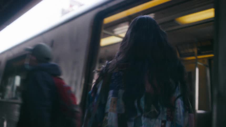 Woman at a station getting on the train and leaving shortly afterwards