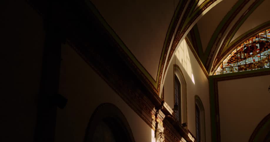 The interior of a grand architectural structure with high arched ceilings