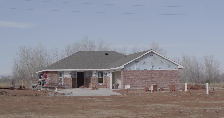 Brick house that appears to be under construction on a clear fall day