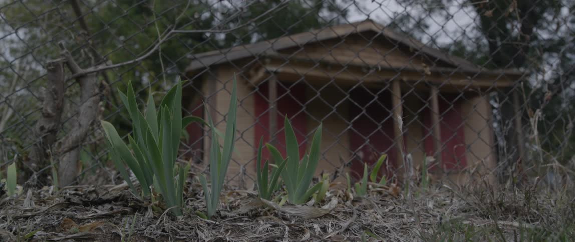 Behind the fence is a small home