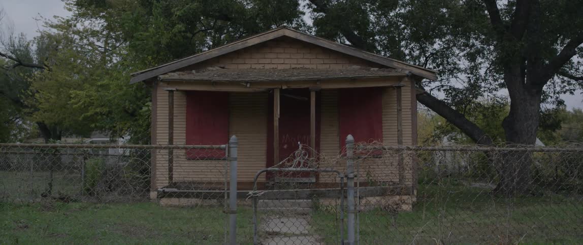 Abandoned house on a grassy lot