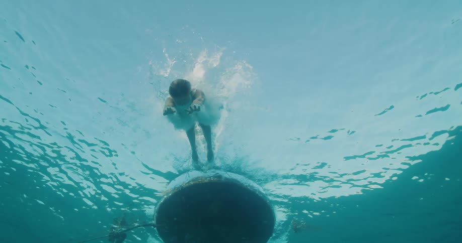A woman dives off the raft into the water