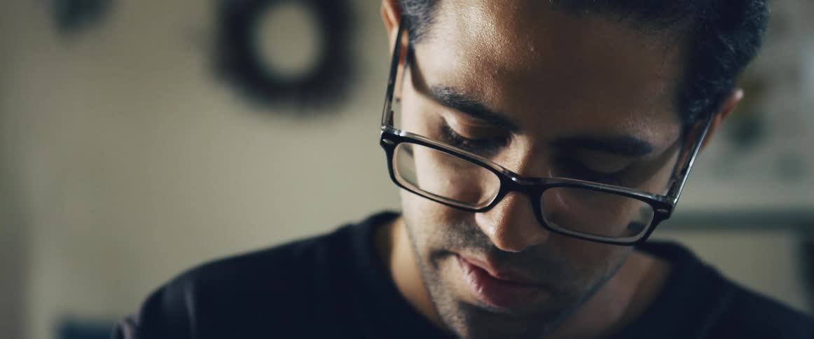 Portrait of a man with prescription glasses preparing food