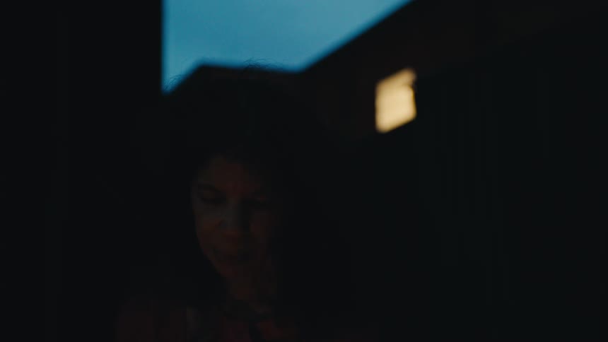 Face of a woman outdoors in a neighborhood at night