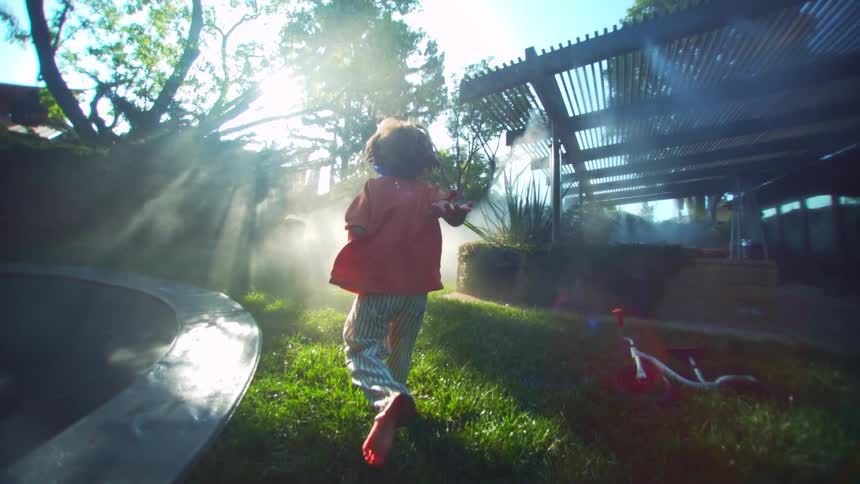 A child is running through the yard