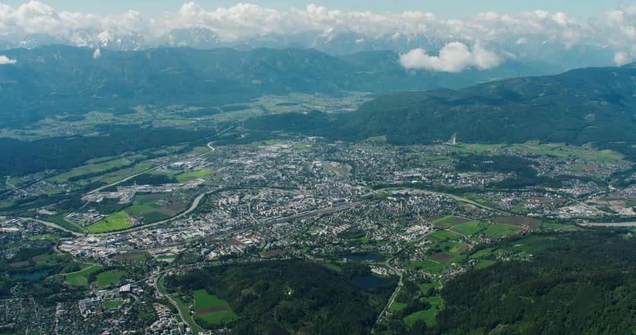 Aerial scenery of an urban city surrounded by mountains and vegetation