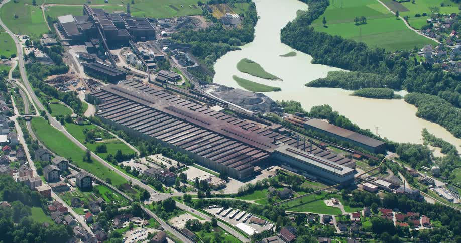 A large factory near suburbs and a river