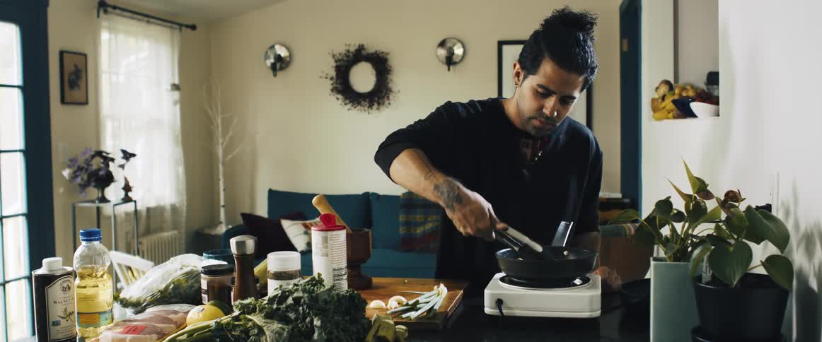 Man in the kitchen cooking in a pan