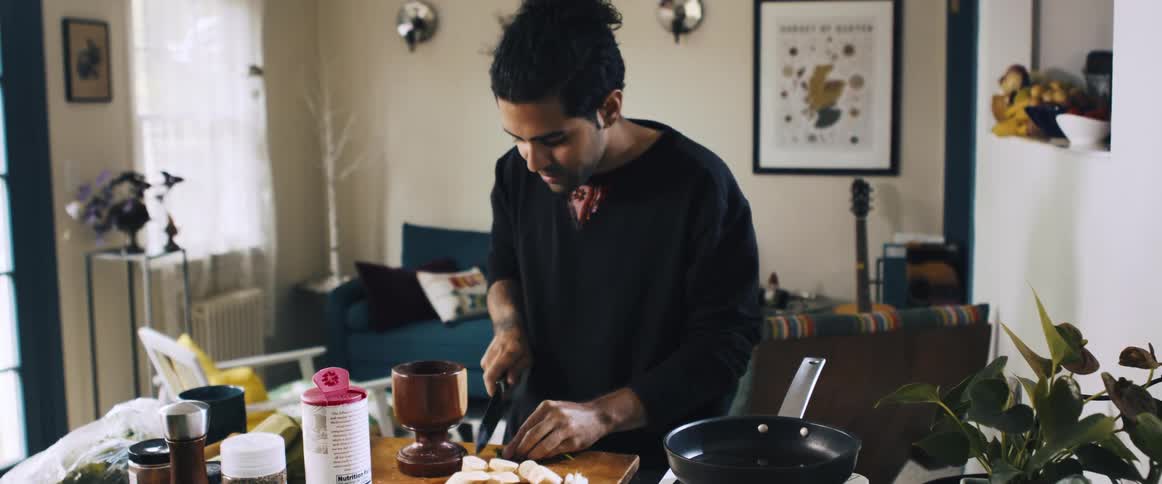Man with a knife cooking on a cutting board