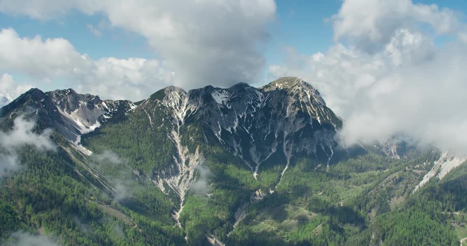 Panorama of a mountain valley with clouds around