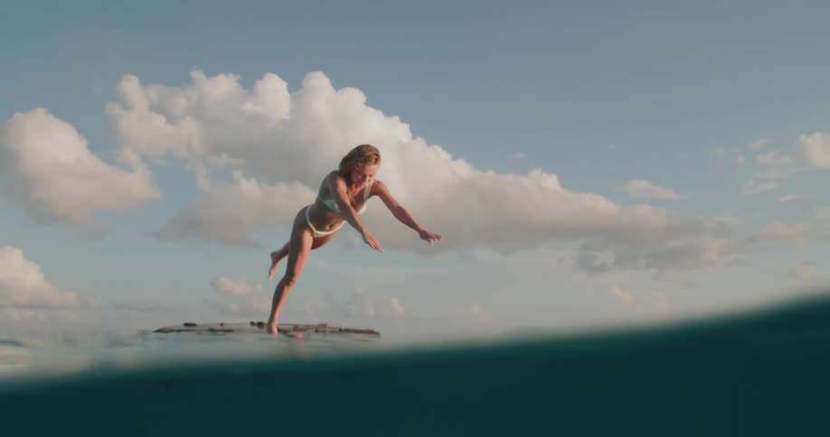 A woman dives into the water in slow motion