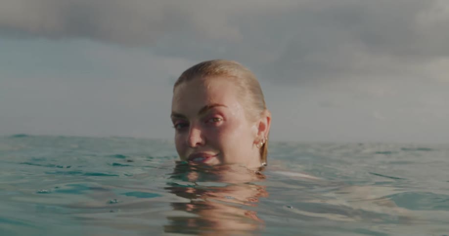 Portrait of a smiling blonde woman in an extensive ocean