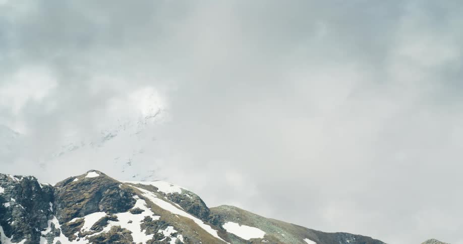 Snowy rocky mountain on a cloudy day