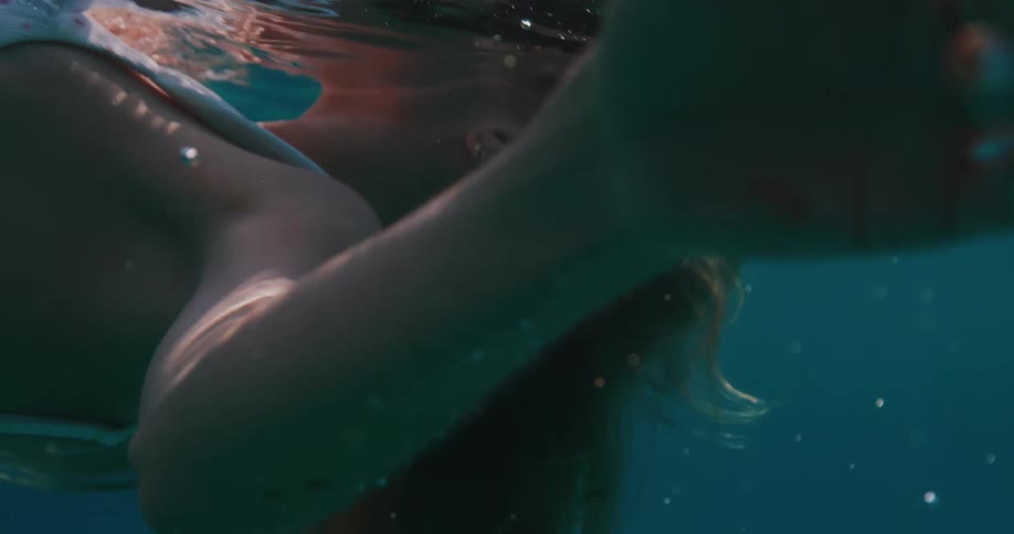 Lighthaired woman floating in a pool