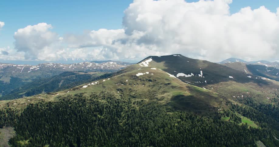Aerial panorama of mountain ranges with clouds nearby
