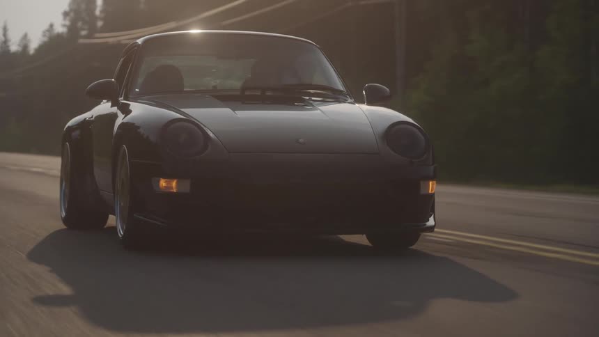 Sports cars traveling on a highway