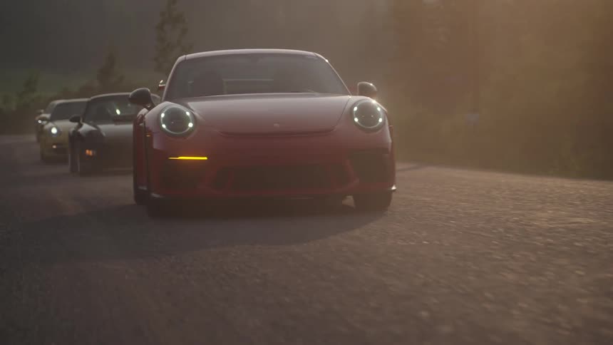 Porsche 911 on a highway with the turn signal on