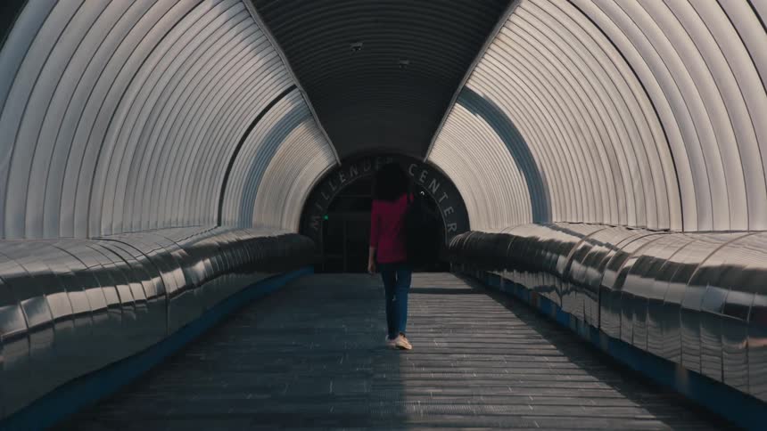 Metallic modern hallway covered with a woman walking