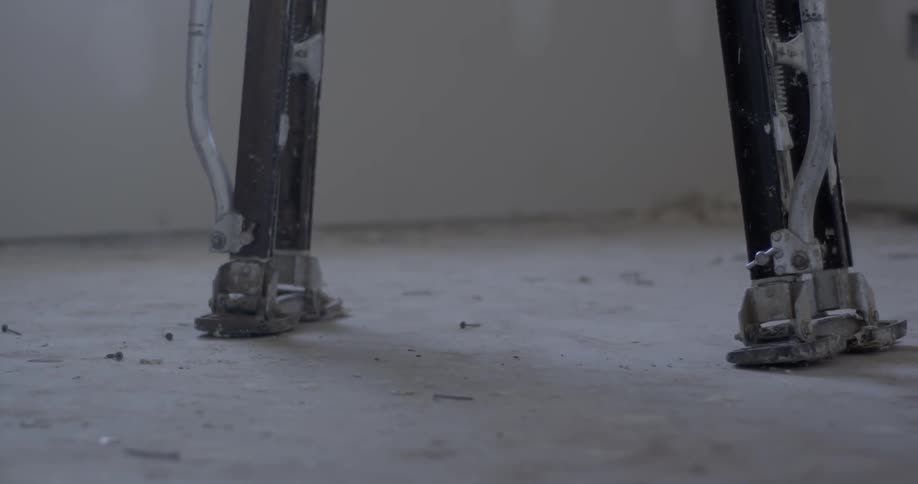 Metal legs walk across floor
