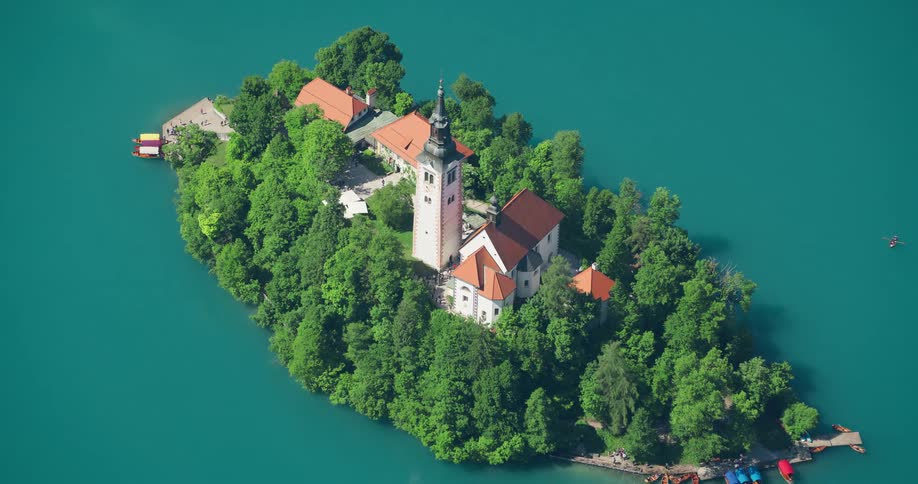 Aerial panorama of an island in a blue ocean with tower and monasteries