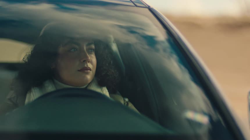 Woman driver inside the car opens the door and gets out