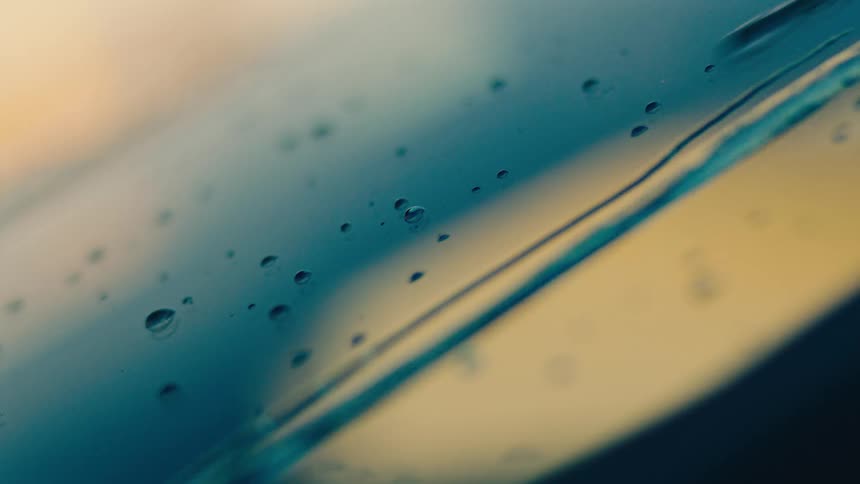 Water drops dripping on an abstract glass