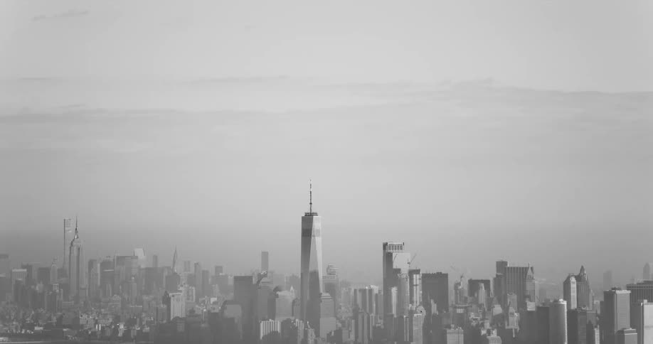 One world trade center and surrounding skyscrapers remain visible through fog