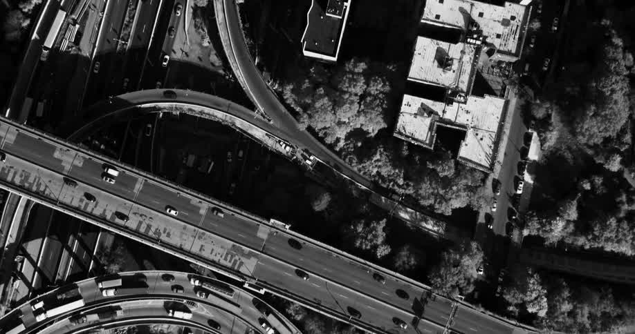Top view of a metropolis with highways and overpasses with heavy vehicle traffic