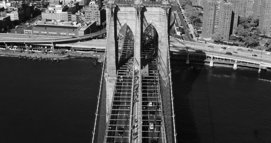 Heavy traffic moves across a bridge and into a dense city
