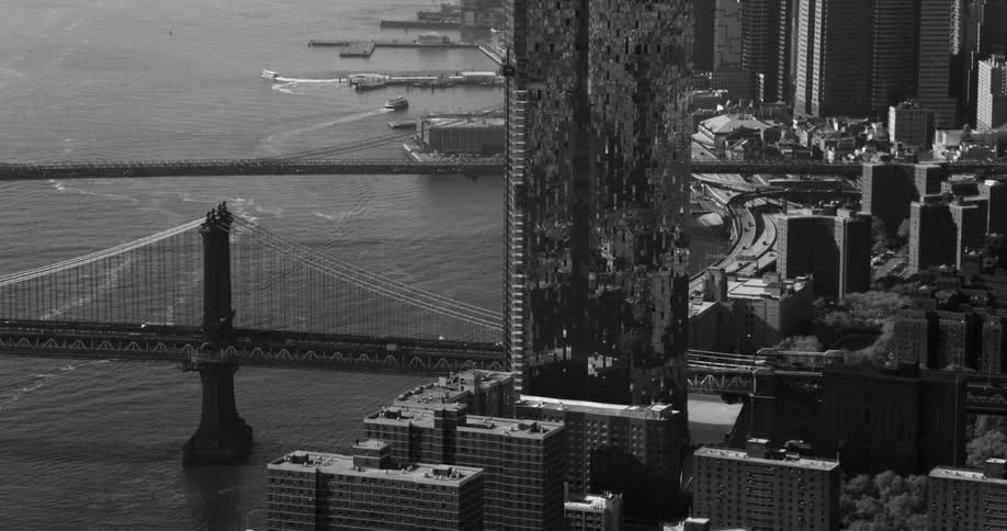 Aerial panorama of a metropolis with modern skyscrapers and a bridge over the sea with vehicle traffic