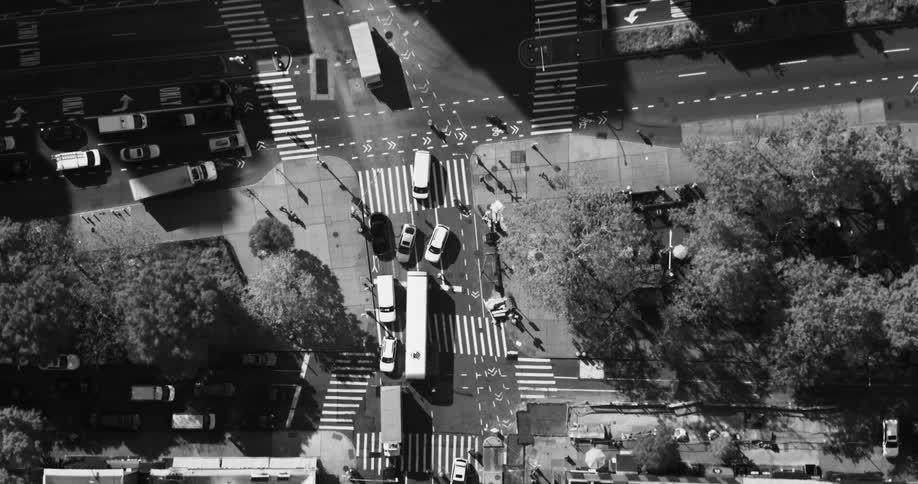 Aerial view city streets and rooftops black and white