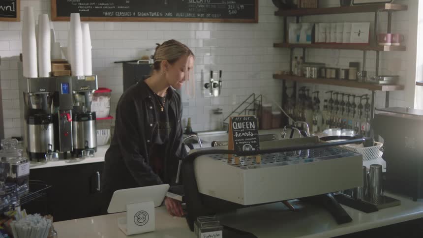 Woman taking a small notebook in a coffee shop