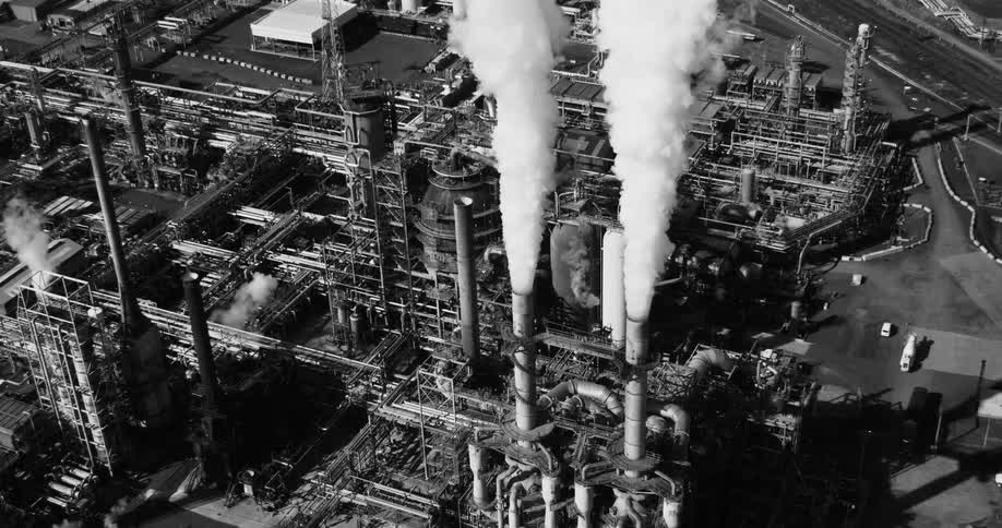 Aerial view of utility plant dual smoke stacks black and white