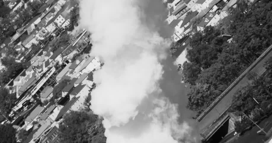 A large amount of white smoke coming from an industrial tower
