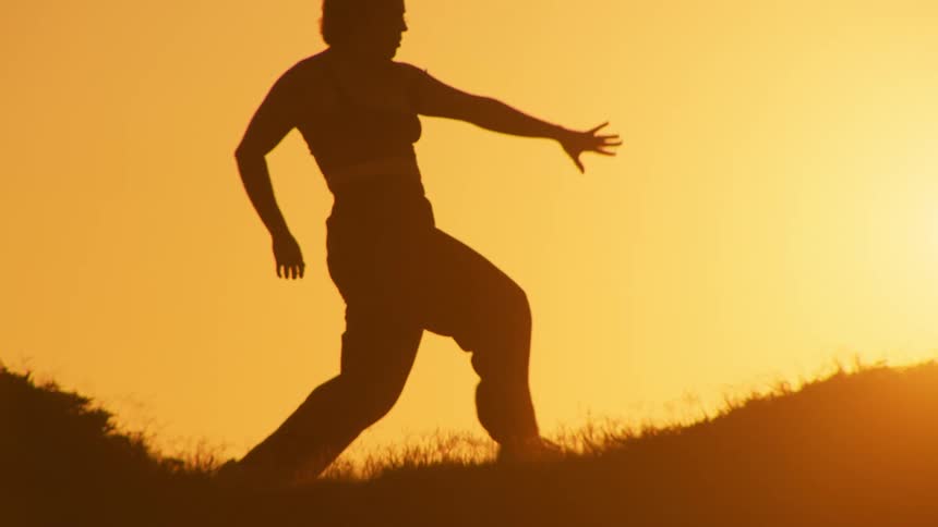 A woman stretches on a grassy area